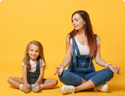 mother and daughter meditating to promote calm and relieve stress