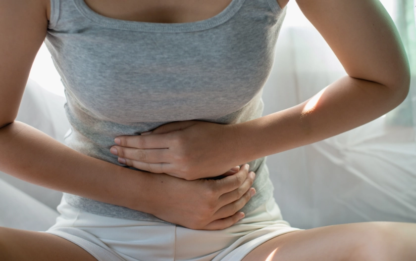 teen experiencing physical symptoms like headaches or stomach discomfort